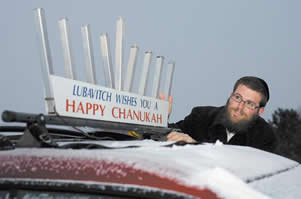 Rabbi Mendy Bukiet of Chabad of Bradenton displays a menorah on the roof of his 2003 Sonata, which will light up during Hanukkah.